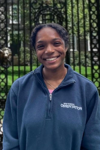 Simone posing in front of the Van Winkle Gates in her Bruno Fellows quarter zip