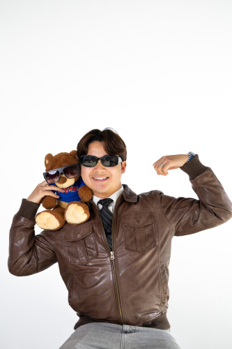 Jeanus posing with a Bruno bear stuffed animal on his shoulder