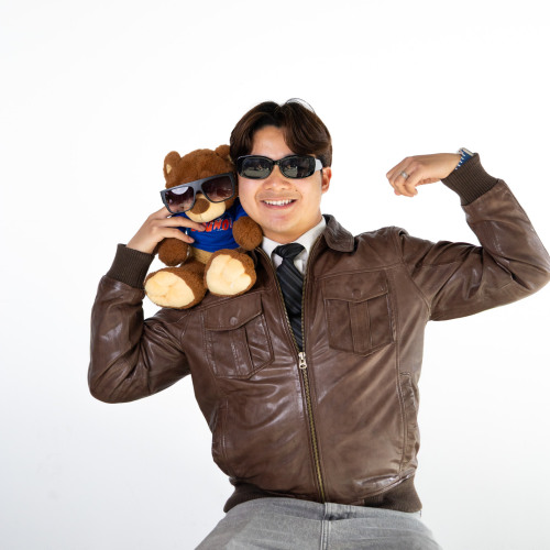Jeanus posing with a Bruno bear stuffed animal on his shoulder