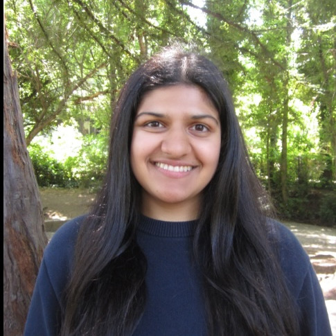Student smiling in forest area