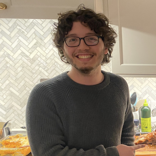 Student standing in kitchen infront of food on counter