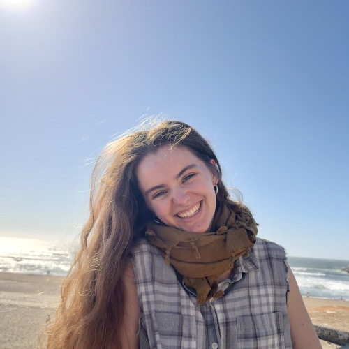 Student smiling at the beach