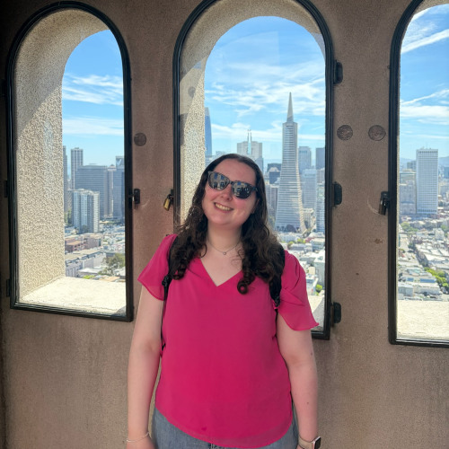 Student posing for picture infront of city landscape