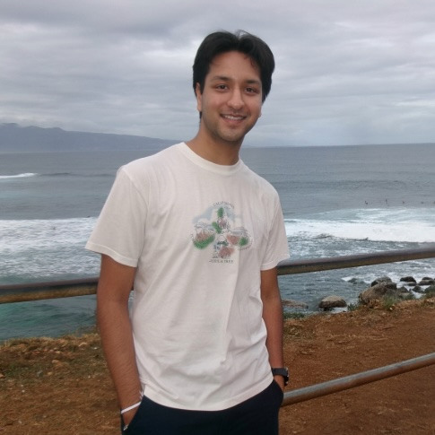 Student posing in front of the ocean