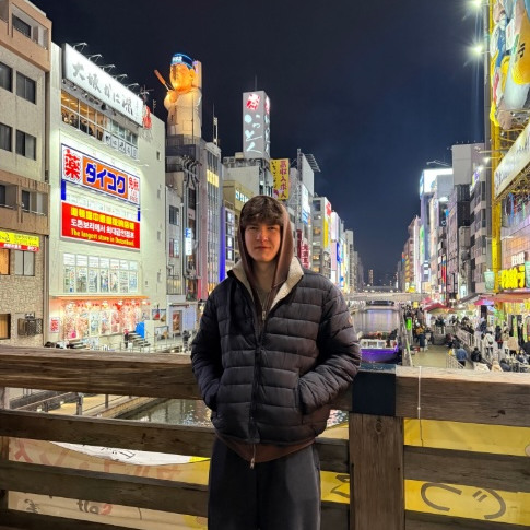 Student posing infront of city street in Asia 